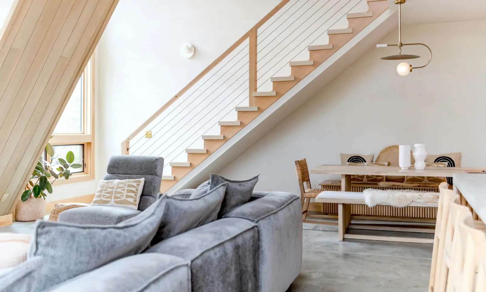 Bright furnished rental interior with natural wood stairs